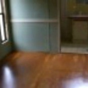 A stained wood flooring in an empty bedroom.