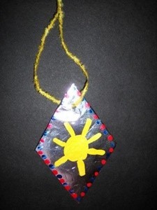 kids' craft necklace with sun painted on diamond shape