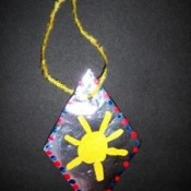 kids' craft necklace with sun painted on diamond shape
