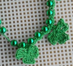 shamrocks crocheted onto plastic bead necklace