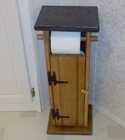Toilet paper holder built to resemble an outhouse.
