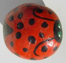 Rock painted to look like ladybug.