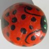 Rock painted to look like ladybug.