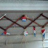 An expandable coat rack with red, white and blue ornaments hanging from it.