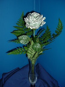 Rose made from dollar bill attached to stem and in vase.