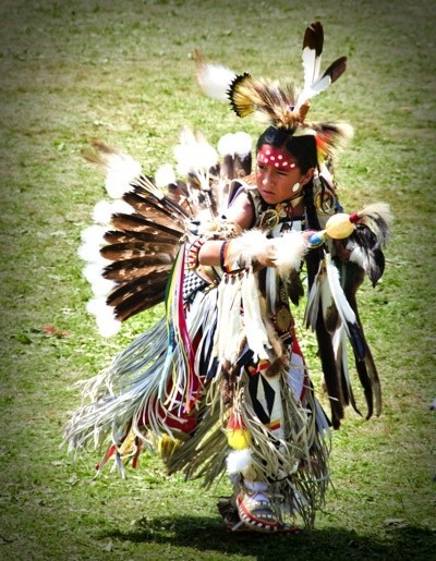 A First Nations tribe member, dressed in traditional costume.