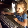 Young girl using computer mouse.