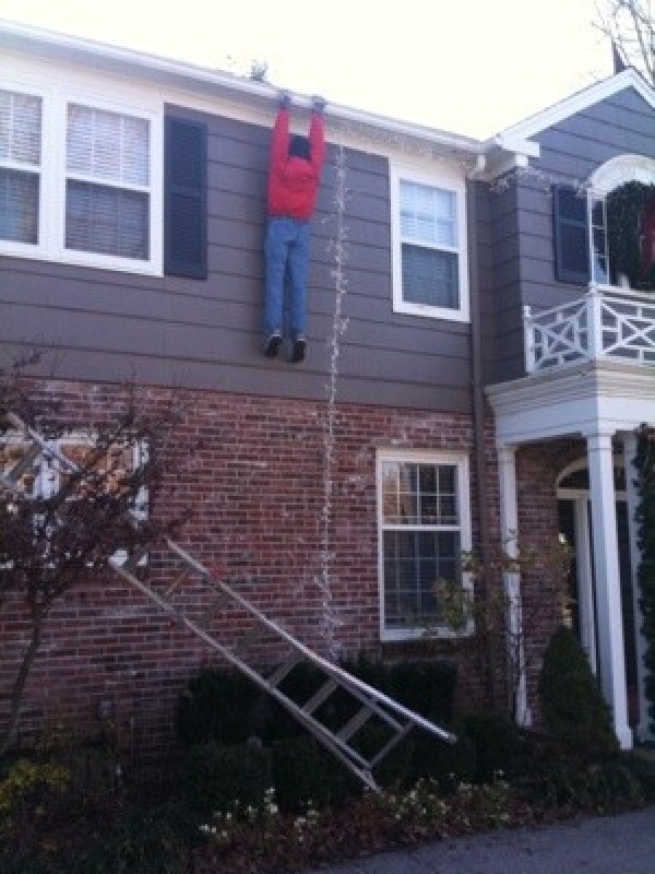 A decoration of a man fallen off the ladder when decorating.