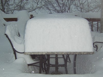 Snow covered table on deck.