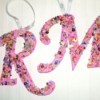 The letter "R" and "M" decorated and ready to hang on a Christmas tree.