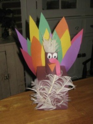 Tissue Box Turkey made from construction paper and feathers.