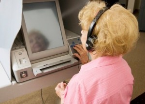 blind_woman using assistive technology to vote.
