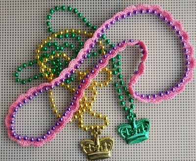 Gold, pink, and green necklaces.