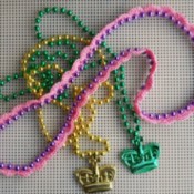 Gold, pink, and green necklaces.