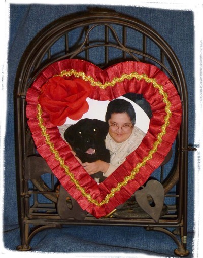 A picture frame made from a heart shaped candy box.