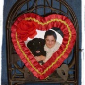 A picture frame made from a heart shaped candy box.