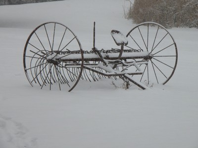 Snow covered farm rake.