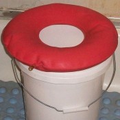 A makeshift shower seat made from a bucket.