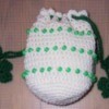 White crochet bag with green beads and shamrocks.