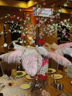 centerpiece with gumboils in vase filled with feathers and flowers