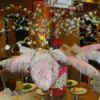 centerpiece with gumboils in vase filled with feathers and flowers