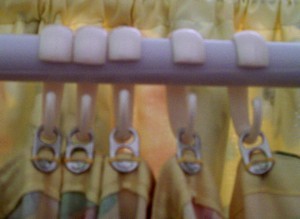 Pop tabs attached to shower curtain hooks.