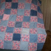 A denim and pink quilt made from recycled fabrics.