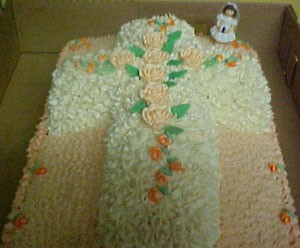 A cake shaped like a cross celebrating First Communion