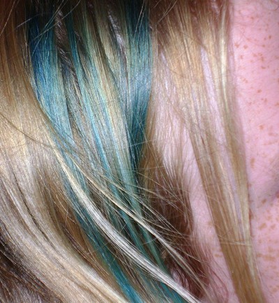 Green streaks in blond hair.