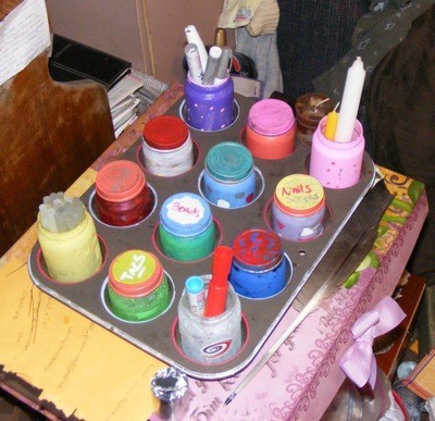 A craft organizer from a muffin tin and baby food jars, holding supplies.