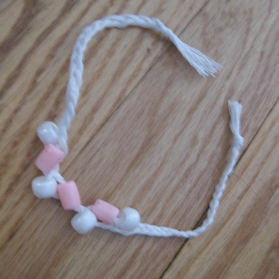 White bracelet with pink and white beads.