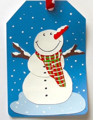 gift tag with snowman made from recycled paint chips, ribbon, and paint
