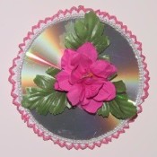 A recycled CD as a floral wall hanging.
