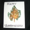 A homemade happy Thanksgiving card with a painted leaf design.
