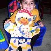 Child holding a paper gingerbreadman.