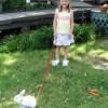 Girl walking a white rabbit.