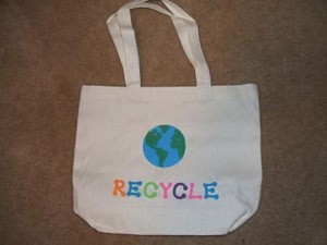 Plain tote bag decorated with earth and "recycle".