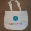 Plain tote bag decorated with earth and "recycle".