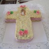 A cake shaped like a cross to celebrate First Communion.