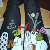 A pair of jeans painted with a Halloween scene from Charlie Brown.