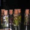 Glass bottles with flowers preserved in oil.