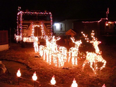 Christmas lights with reindeer pulling a semi-truck.