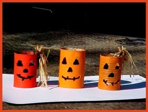 A collection recycled cans decorated to resemble jack-'o-lanterns.