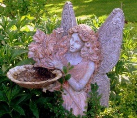 A garden fairy holding a shallow bowl.