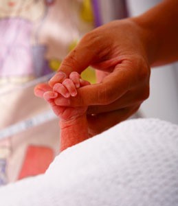 hand holding a tiny baby hand