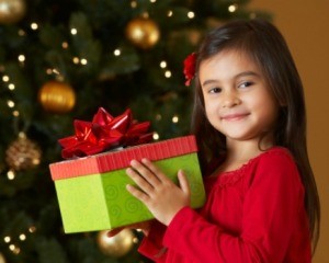 A young girl holding a gift.