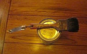 Can opener attached to paint brush.