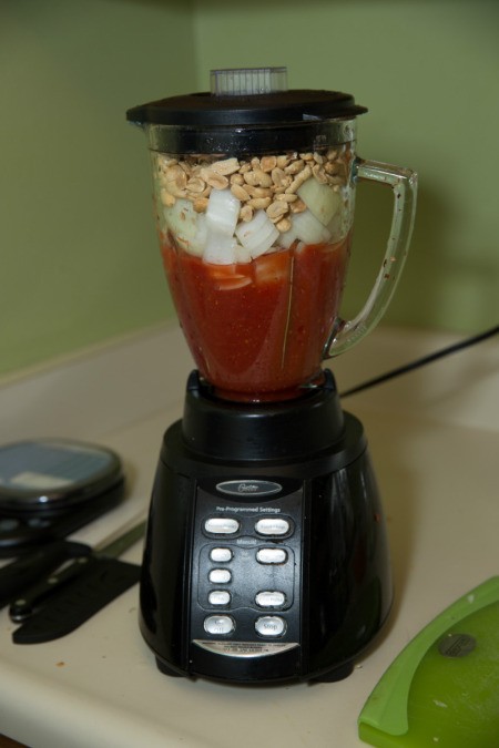 Blender with ingredients for African peanut soup.