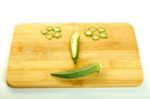 Okra laid out to look like a smiley face.