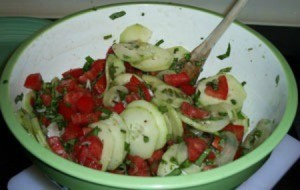 Basil Tomato Salad with Grilled Chicken - stirring together ingredients